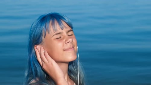 Modern Girl with Music By Waterfront