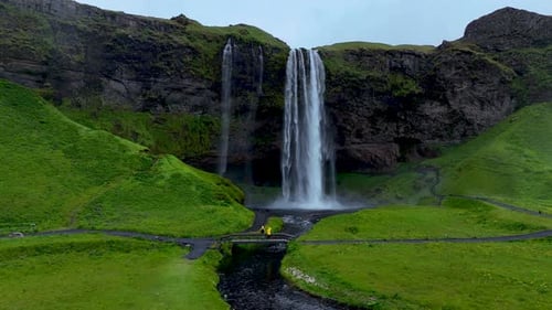 Majestic Seljalandsfoss Waterfall Cascading Through Lush Green Valleys in Icelands Serene Landscape
