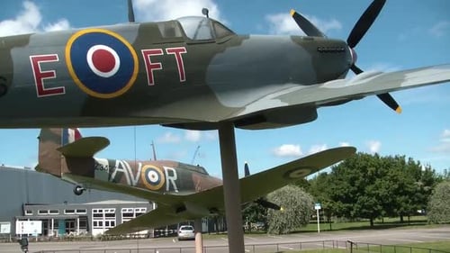 Historical airplanes on display at the main entrance of the RAF museum in London.