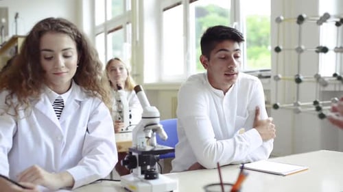Teacher Teaching Biology to High School Students in Laboratory