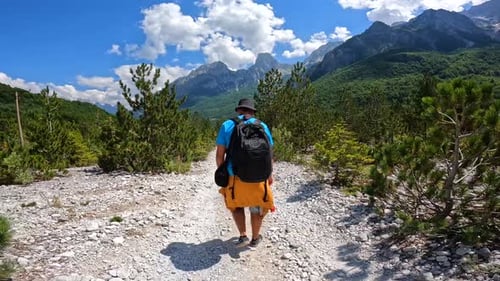A man walking on the trail on the Valbona Valley trekking to Theth, Theth National Park, Albanian Al