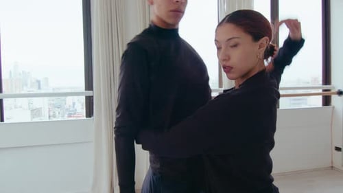 Couple Performing Contemporary Dance and Looking at Camera in Studio