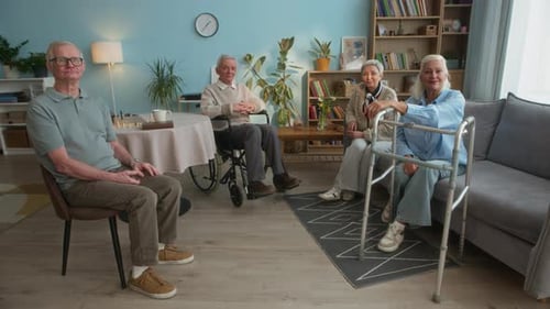 Four Senior Adults Sit Together in Living Room