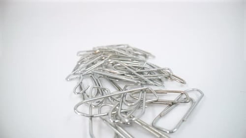 Metal paper clips close up isolated 4K
