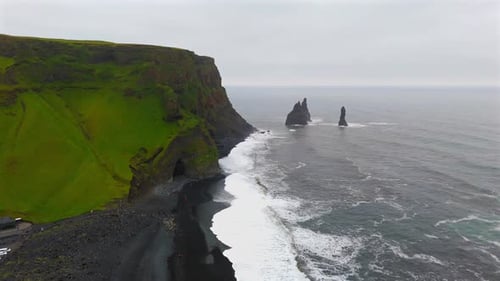 Marvel at the striking contrast of Reynisfjara’s black sands against the blue waters of the Atlantic
