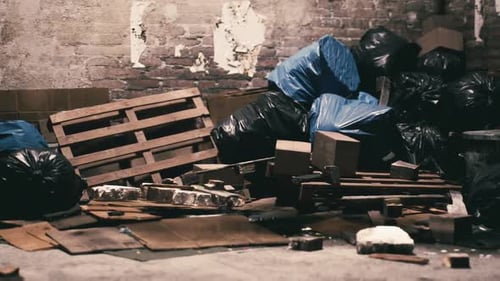 Discarded Materials and Trash Pile in an Abandoned Warehouse Setting