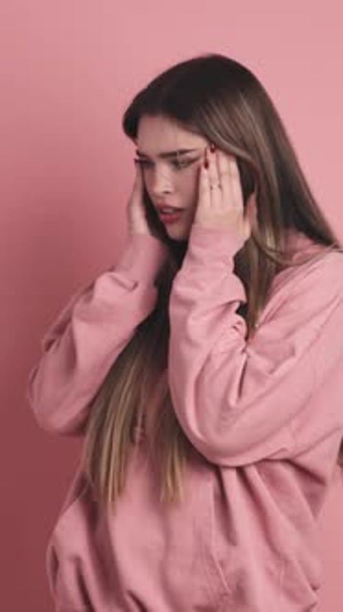 Burdened Young Beauty Woman Standing with Arms Crossed