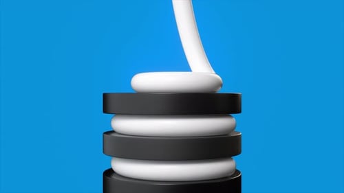 Piping White Cream onto Stacked Black and White Discs