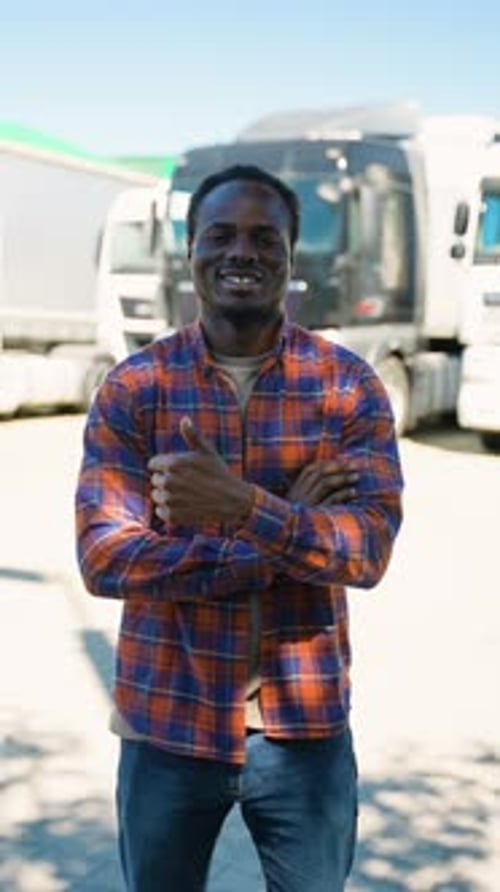 Truck Driver Portrait in Front of Commercial Trucks