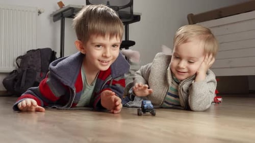 Two Happy Boys Playing with Toy Cars