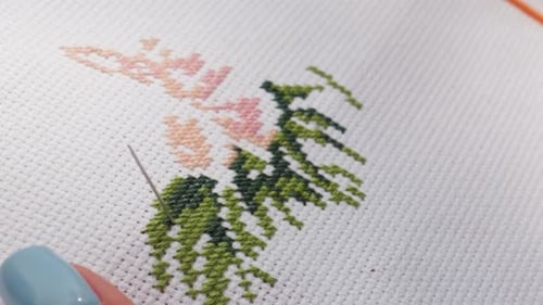 Close Up Designer Embroidering Fabric Passing Needle Through Stitch