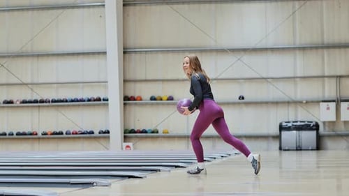 Woman Throws Bowling Ball In Large Hall Side Angle Slow Motion Scene Indoors
