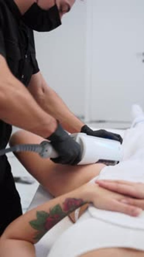 Woman Receiving Thigh Treatment in Clinic