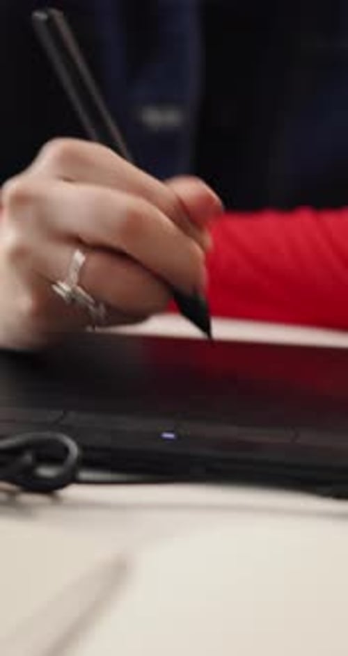 Woman Using Stylus and Tablet for Graphic Design