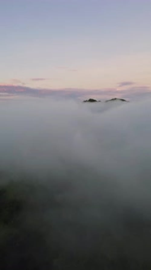 Vertical Drone Footage of fog in the mountain at Gorontalo, Indonesia