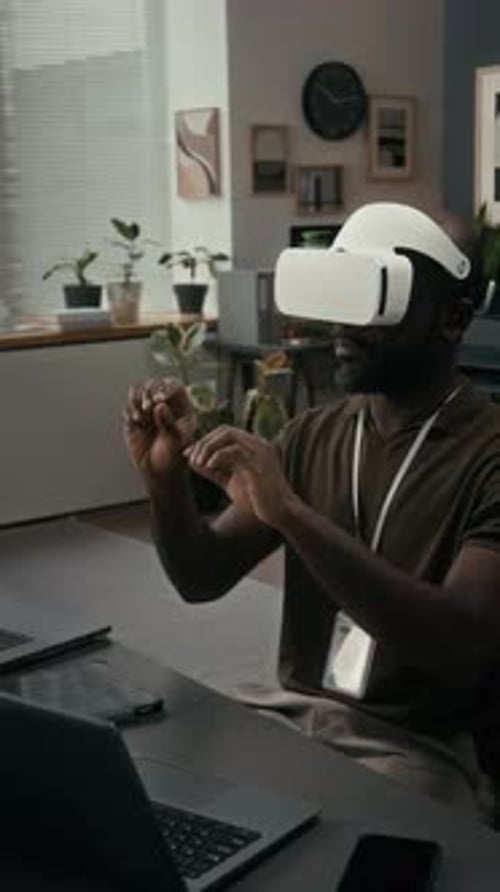 Man Using VR Headset at Desk in Office