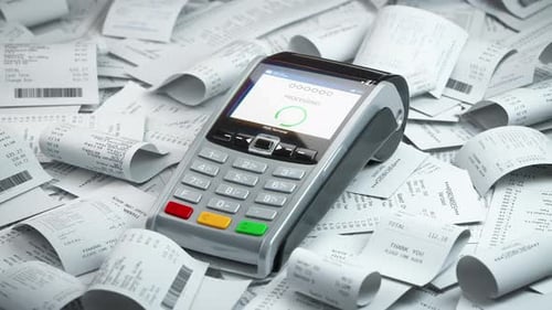 POS Terminal in a Heap of Receipts Payment for a Lot of Expenses or Purchases Concept