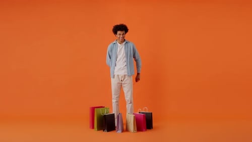 Young Curly Man Indicating with His Hand on Discount Sign