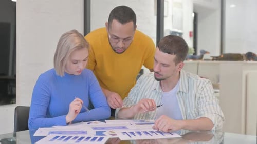 Creative Mixed Race People Working on Documents in Office