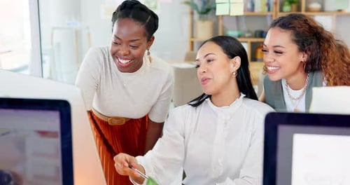 Three Women Collaborating at Computer in Modern Office