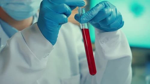 Medical Researcher Handling Blood Sample in Lab