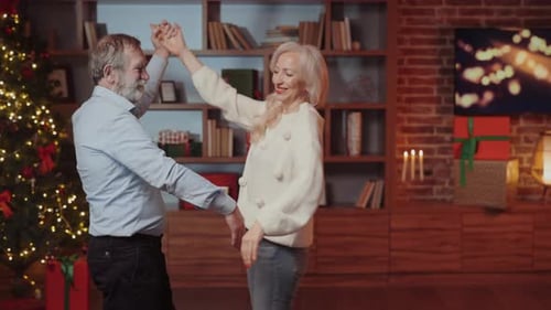 Mature Couple Dancing at Home for Christmas