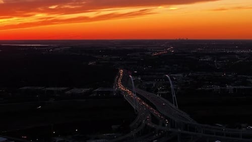 Aerial view of sunset cityscape with traffic, United States.