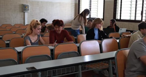 Mature Teacher Working with Students Inside Classroom at School University Academic