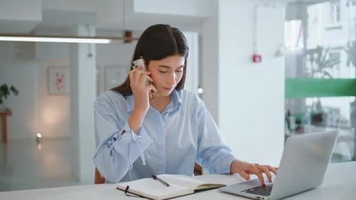 Young Woman Working and Talking on Phone