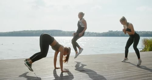 Sportswomen Warming Up Before Running on Street