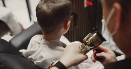 Child Gets a Haircut at the Barber Shop