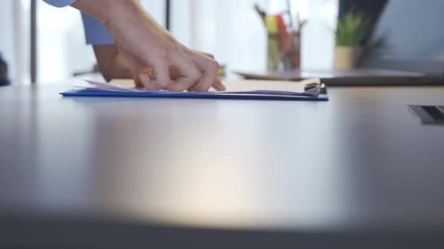 Businessman gets angry at the article he reads in his office.