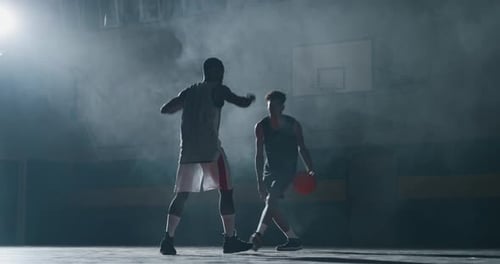 Cinematic slow motion shot of young professional male players are practicing a basketball work out
