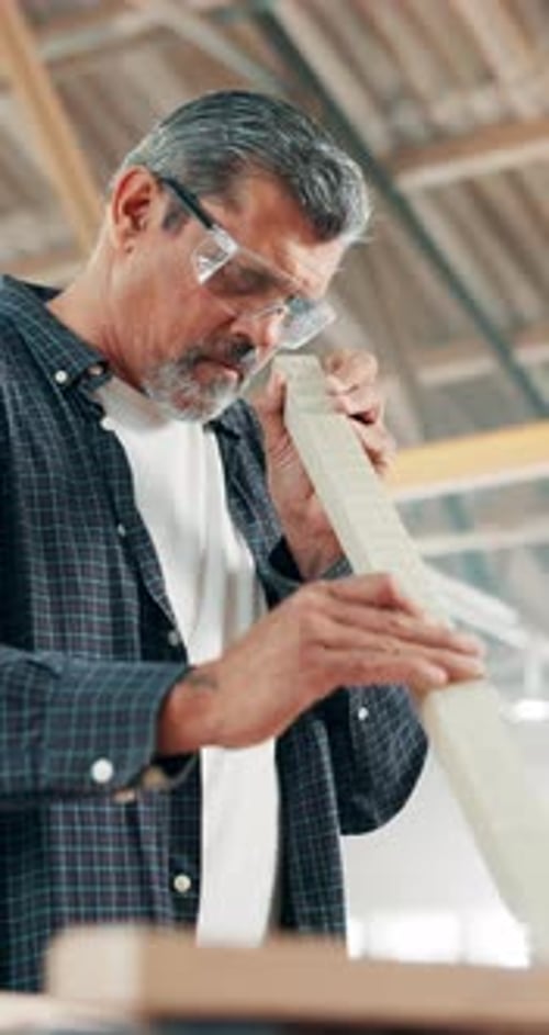 Man, wood and sandpaper in workshop, carpenter and manufacturing furniture