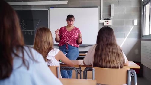 High School Teacher Explaining Lesson to Students in Classroom