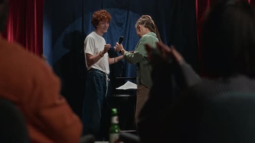 Audience Applauding as Redhead Comedian Presenting Female Comedians Entrance
