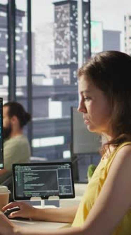 Woman Working at Computer in Bright Urban Office