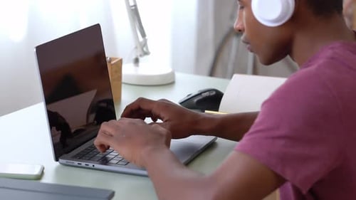 Man Works with Concentration on His Laptop at Home