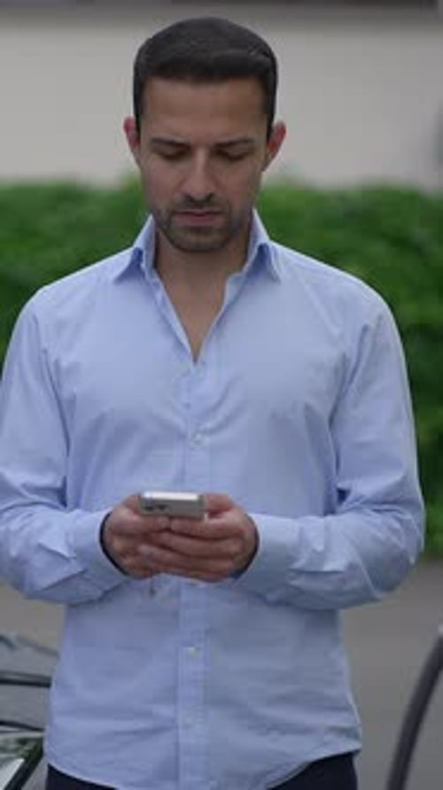 Young Adult Using Smartphone in Urban Setting