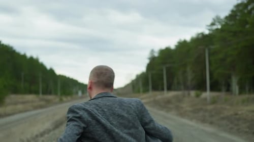 Man Running on Train Tracks in the Countryside