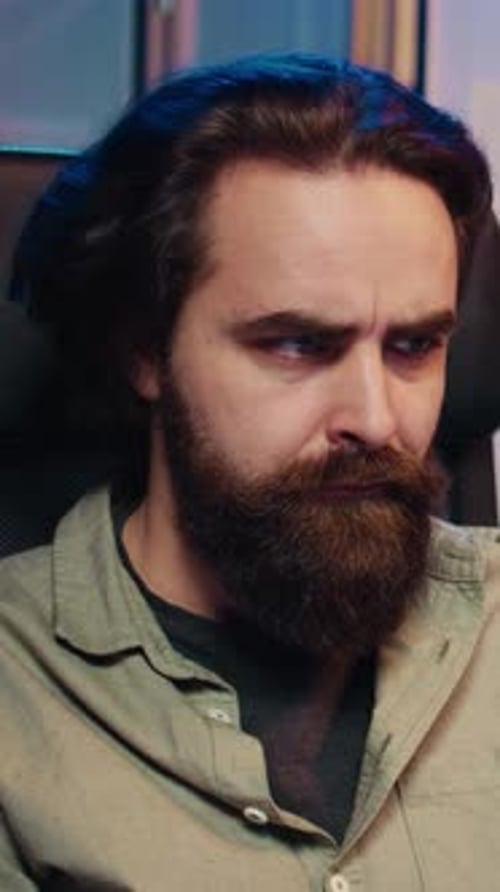 Man with Beard Resting Chin On Fist