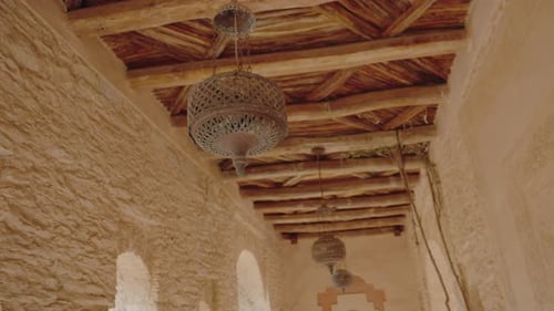 Traditional Moroccan Hallway with Hanging Lanterns and Wooden Beams
