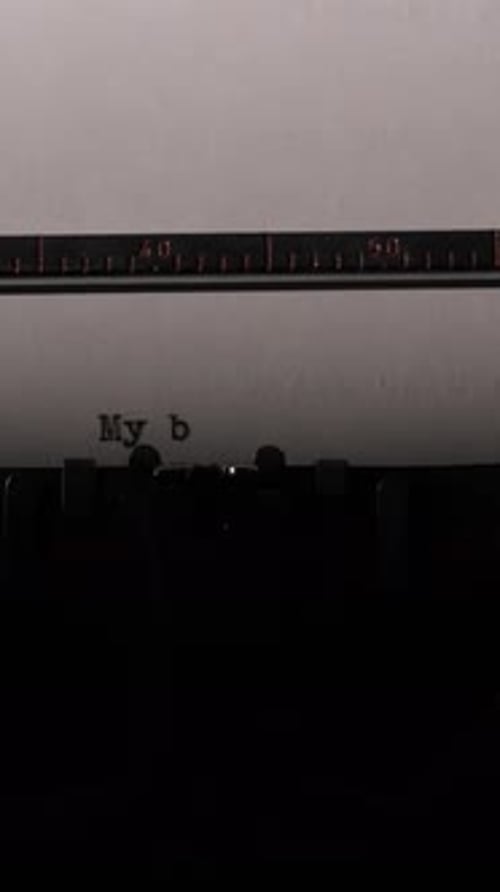 Typewriter types the words "My blog" on paper