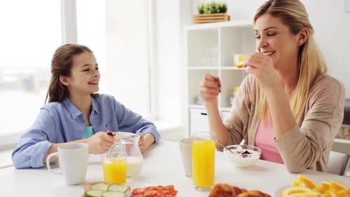 Mother and Daughter Have Healthy Breakfast Together at Home