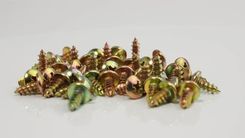 Metal screws on a white background. Rotating screws for driving into plastic.