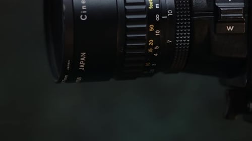 Close-up old analog Super 8 camera lens on a dark background