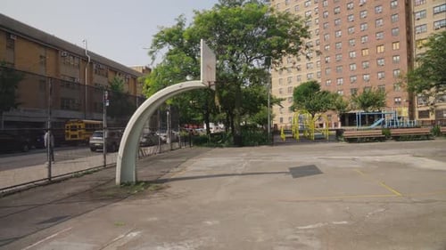 Empty basketball court in the backyard of the school with Highrise buildings in background, New York