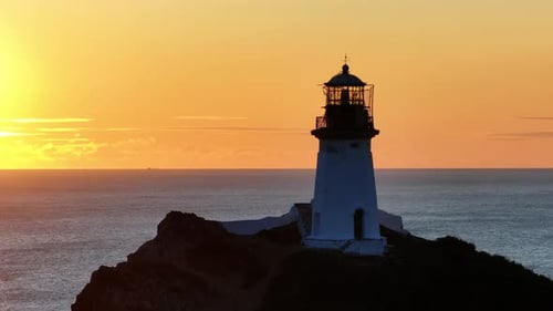 The Guiding Beacon A Majestic Lighthouse Perched on a Coastal Cliff Illuminating the Vast Ocean