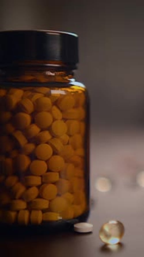 Pill Bottle Spills Medicine on Surface