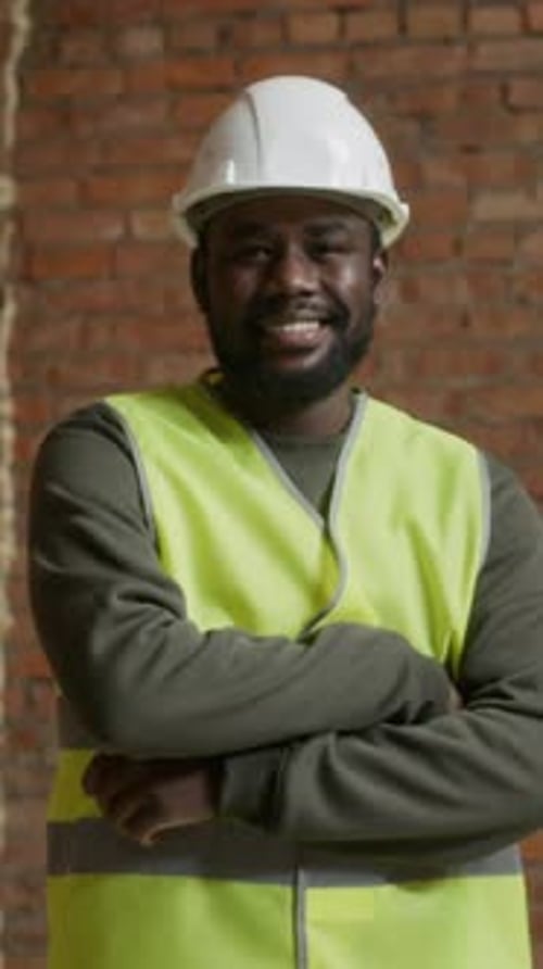 Smiling Construction Worker Wearing Hard Hat And Safety Vest